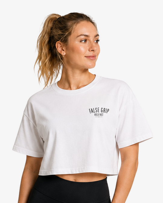 Crop T-Shirt Fueled by Pre-Workout da False Grip em Vintage White, com corte cropped largo e assinatura False Grip no peito.